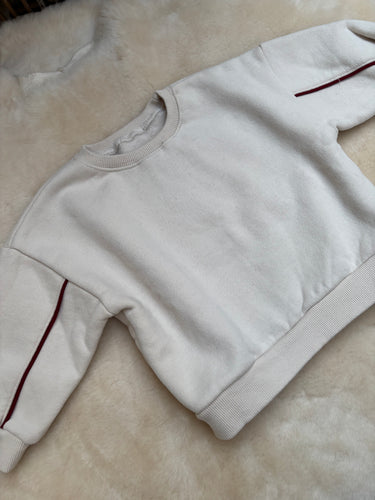 Oversized sweater with red arm detail