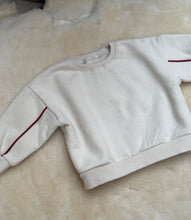 Oversized sweater with red arm detail