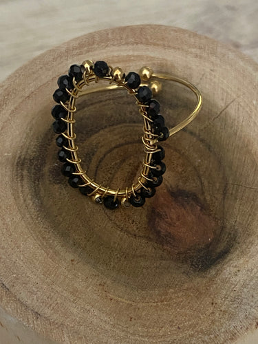 Gold and black oval stone ring