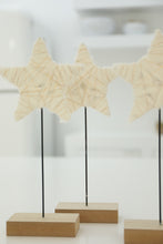 cream and gold star on stand