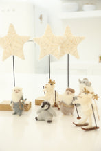 cream and gold star on stand