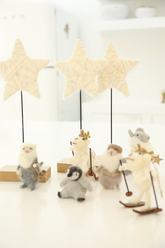 cream and gold star on stand