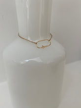 gold cross bracelet on lurex string