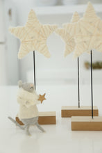 cream and gold star on stand