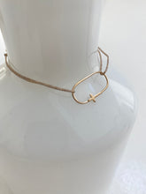 gold cross bracelet on lurex string