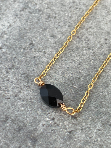 Gold chain necklace with black stone