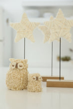 cream and gold star on stand